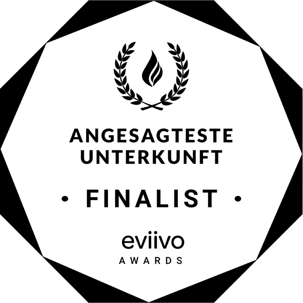 Schwarz-weißes Logo mit einem Lorbeerkranz und einer Flamme oben, darunter der Text "Angesagteste Unterkunft Finalist" und "eviivo Awards".